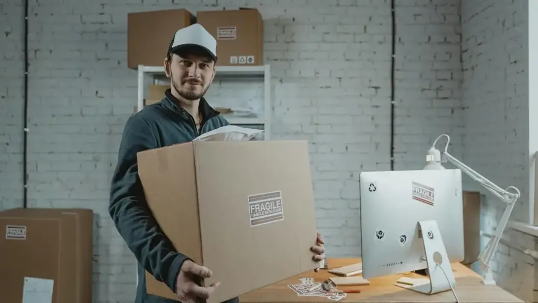 Man carrying storage box looking at camera.