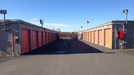 Outdoor storage units at Dimond Mini Storage with gated entrance in the rear.
