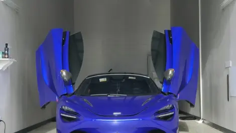 Blue sportscar in interior storage unit.