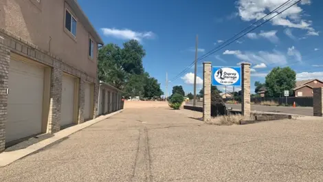 Exterior of outdoor storage units at Osprey Storage Thatcher facility with permanent signage near the street.