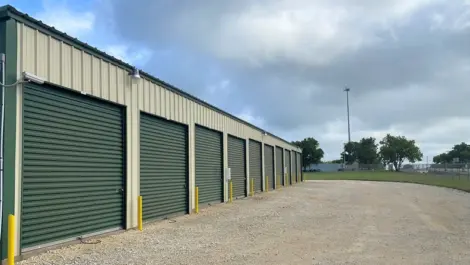 Wide drive aisle and rows of roll-up storage units at Rio Vista Mini Storage.