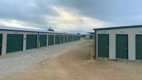 Wide drive aisle and rows of roll-up storage units at Rio Vista Mini Storage.
