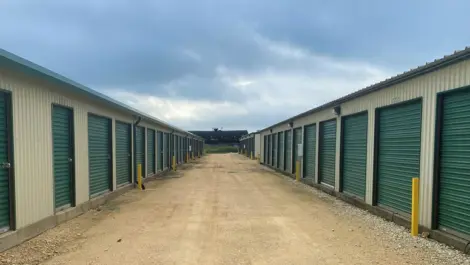 Wide drive aisle and rows of roll-up storage units at Rio Vista Mini Storage.
