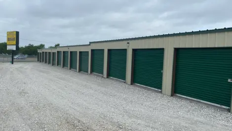 Wide drive aisle and rows of roll-up storage units at Rio Vista Mini Storage.