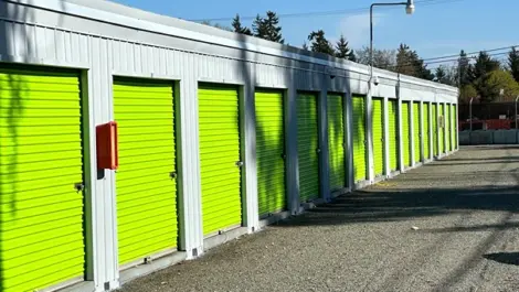 Drive-up storage units with metal roll-up doors at Sales Road Storage facility.