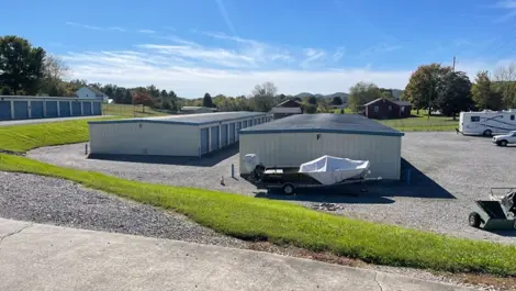 Drive-up storage units with metal doors and wide access lanes with vehicle storage at Volunteer Storage Seymour.