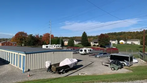 Clean gravel driveways between rows of storage units and vehicle storage at Volunteer Storage Seymour.