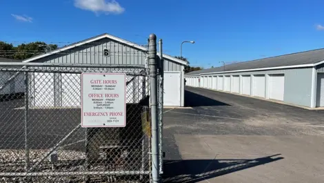 Roll-up doors on drive-up units and door units with wide paved aisle at fenced Osprey Storage Shaver.