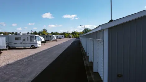 Open gravel area for vehicle storage and paved area roll-up units at Osprey Storage Shaver.