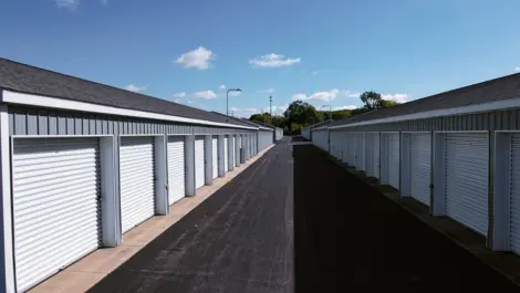 Clean paved driveways between storage buildings at Osprey Storage Shaver.