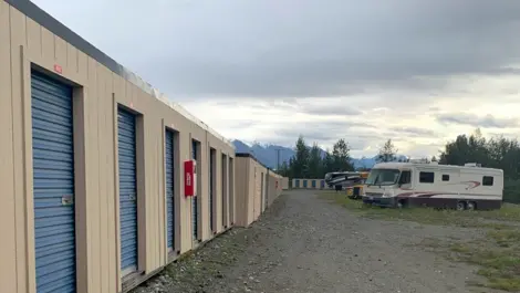 Outdoor storage units and vehicle storage at Snowbank Mini Storage facility.