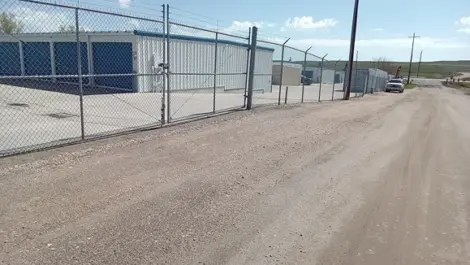 Exterior of Speedway Storage with multiple unit rows and fencing.