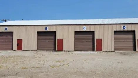 Clean roll-up doors and bright exterior at Storage Crib.