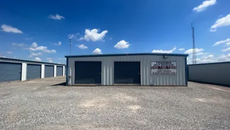 Exterior of outdoor storage units with permanent signage at Texoma Self Storage facility.