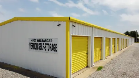 Exterior units with drive-up access and metal roll-up doors at Vernon Self Storage.