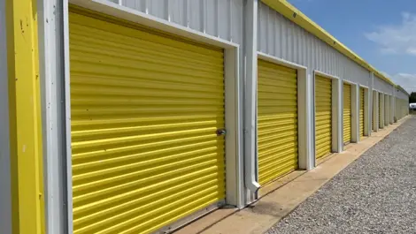 Gravel road in front of roll up door storage units at Vernon Self Storage.
