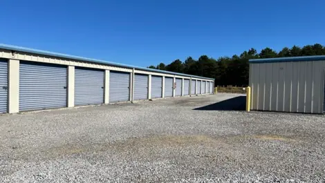 Storage unit row and paved access path at Volunteer Storage Vonore.