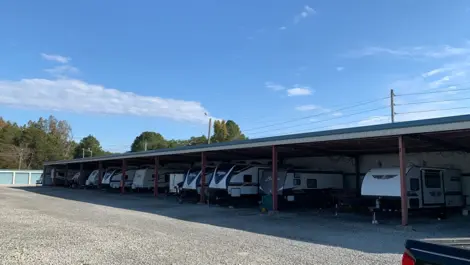 Wide view of lot layout and covered parking units at Volunteer Storage Vonore.