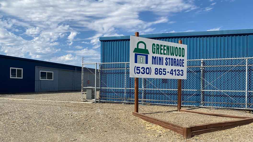 Greenwood Mini Storage signage in front of storage buildings