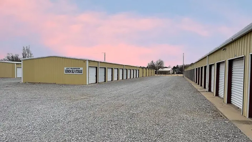 Vernon Self Storage outdoor units under pastel colored sky.
