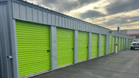 Exterior of outdoor green storage units at Mountain Vista North Mini Storage.