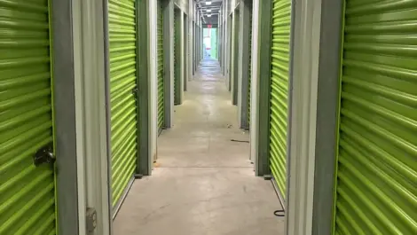 Exterior of indoor green storage units at Mountain Vista North Mini Storage.
