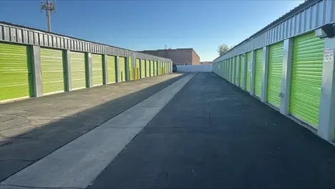 Exterior of outdoor green storage units at Mountain Vista North Mini Storage.